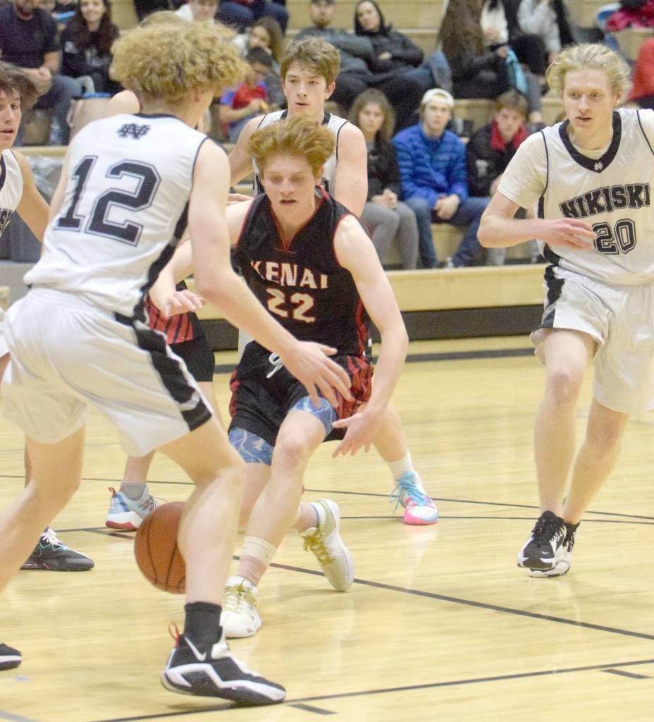 Kenai Centrals Wade James loses the ball in front of Nikiskis Brady Bostic on Friday, Jan. 14, 2022, at Nikiski High School in Nikiski, Alaska. (Photo by Jeff Helminiak/Peninsula Clarion)