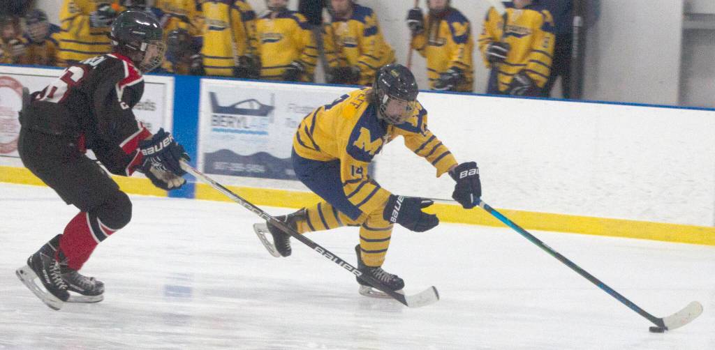 Homers Kazden Stineff moves the puck againsts Houstons Brayden Johnson on Friday, Jan. 21, 2022, at the Kevin Bell Ice Arena in Homer, Alaska. (Photo by Sarah Knapp/Homer News)