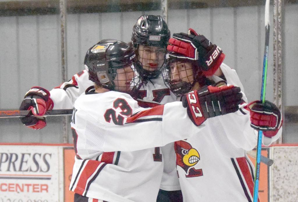 Kenais Caden Warren, Landon Cialek and Logan Mese celebrate a goal by Mese against Palmer on Friday, Jan. 21, 2022, at the Kenai Multi-Purpose Facility in Kenai, Alaska. (Photo by Jeff Helminiak/Peninsula Clarion)