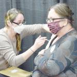 Kenai Public Health Nurse Sherra Pritchard gives Love Inc. Director Leslie Rohr a COVID-19 booster shot during the Project Homeless Connect event in Soldotna on Wednesday, Jan. 26, 2022. (Camille Botello/Peninsula Clarion)