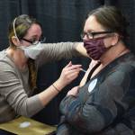 Kenai Public Health Nurse Sherra Pritchard gives Love Inc. Director Leslie Rohr a COVID-19 booster shot during the Project Homeless Connect event Soldotna Regional Sports Complex in Soldotna on Wednesday, Jan. 26, 2022. (Camille Botello/Peninsula Clarion)