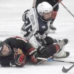 Kenai Centrals Koda Norbeck and Soldotnas Gehret Medcoff battle for the puck Thursday, Jan. 27, 2022, at the Soldotna Regional Sports Complex in Soldotna, Alaska. (Photo by Jeff Helminiak/Peninsula Clarion)