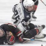 Kenai Central's Koda Norbeck and Soldotna's Gehret Medcoff battle for the puck Thursday, Jan. 27, 2022, at the Soldotna Regional Sports Complex in Soldotna, Alaska. (Photo by Jeff Helminiak/Peninsula Clarion)