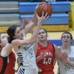 Soldotnas Adarra Hagelund grabs a rebound in front of Kenais Denali Bernard and Emma Beck, and SoHis Tanner Inman, at Soldotna High School on Friday, Jan. 28, 2022, in Soldotna, Alaska. (Photo by Jeff Helminiak/Peninsula Clarion)