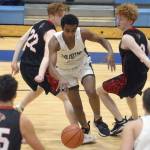 Soldotnas Maleda Denbrock splits Kenais Wade James and Joe Hamilton at Soldotna High School on Friday, Jan. 28, 2022, in Soldotna, Alaska. (Photo by Jeff Helminiak/Peninsula Clarion)