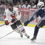 Kenai Centrals Jacob Begich carries the puck against Soldotnas Andrew Arthur on Dec. 14, 2021, at the Kenai Multi-Purpose Facility in Kenai, Alaska. (Photo by Jeff Helminiak/Peninsula Clarion)
