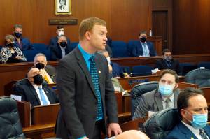 Alaska Republican state Rep. David Eastman, standing, speaks on the House floor on Friday, Feb. 4, 2022, in Juneau Alaska. Alaska House leaders have backed away from a proposal to strip committee assignments from Eastman, who has acknowledged being a member of the far-right organization Oath Keepers, and for now plan to hold at least one hearing on the group. (AP Photo/Becky Bohrer)