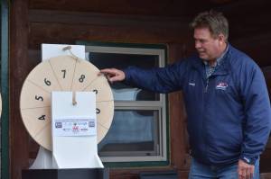 Kenai Mayor Brian Gabriel spins the magic wheel to determine the winners of this years silver salmon derby at the Kenai Chamber of Commerce and Visitor Center on Monday, Sept. 20, 2021. (Camille Botello/Peninsula Clarion)
