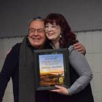 Merrill Sikorski accepts the Soldotna Chamber of Commerces commitment to youth award from Sara Hondel for his work with the Caring for the Kenai ecological competition during the chambers 2021 award ceremony at the Soldotna Regional Sports Complex on Wednesday, Feb. 9, 2022. (Camille Botello/Peninsula Clarion)