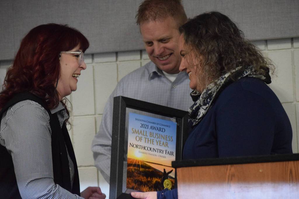 photos by Camille Botello / Peninsula Clarion 
Kimberly Hansen accepts the Soldotna Chamber of Commerces small business of the year award from Sara Hondel for her work at Northcountry Fair during the chambers 2021 award ceremony Wednesday at the Soldotna Regional Sports Complex.