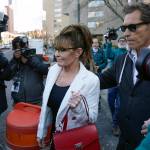 Sarah Palin is escorted to her car by Ron Duguay after leaving the courthouse in New York, Thursday, Feb. 10, 2022. Former Alaska Gov. Sarah Palin told a jury Thursday she felt like she was at the mercy of a “Goliath” when she first learned a 2017 New York Times editorial suggested her campaign rhetoric helped incite a mass shooting. (AP Photo/Seth Wenig)