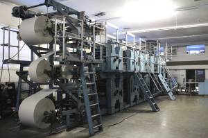 Paper runs through the Peninsula Clarion printing press on Friday, Feb. 11, 2022, in Kenai, Alaska. (Photo by Ashlyn OHara/Peninsula Clarion)
