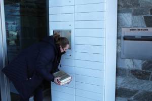 Ryanna Thurman uses a holds locker at the Soldotna Public Library on Friday, Jan. 15 in Soldotna, Alaska. (Ashlyn OHara/Peninsula Clarion)