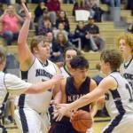 Kenai Centrals Jakob Kvasnikoff tries to escape the trap of Nikiskis Drew Handley and Isaiah Daniels on Tuesday, Feb. 15, 2022, at Nikiski High School in Nikiski, Alaska. (Photo by Camille Botello/Peninsula Clarion)