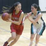 Kenai Centrals Emilee Wilson drives on Nikiskis Savanna Stock on Tuesday, Feb. 15, 2022, at Nikiski High School in Nikiski, Alaska. (Photo by Camille Botello/Peninsula Clarion)