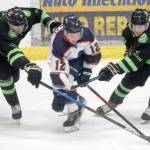 Caleb Huffman and Carter Cloutier of the Kenai River Brown Bears battle Jackson Reineke of the Anchorage Wolverines for the puck Friday, Feb. 18, 2022, at the Soldotna Regional Sports Complex in Soldotna, Alaska. (Photo by Camille Botello/Peninsula Clarion)