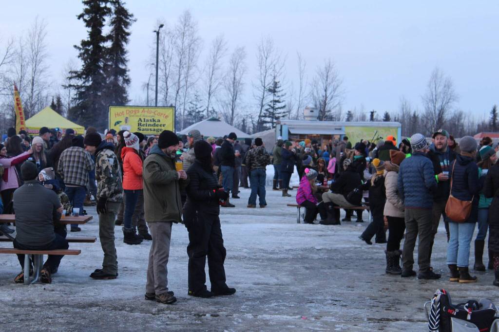 Frozen RiverFest patrons sip beer to live music in Soldotna Creek Park on Saturday, Feb. 19, 2022 in Soldotna, Alaska. (Ashlyn OHara/Peninsula Clarion)