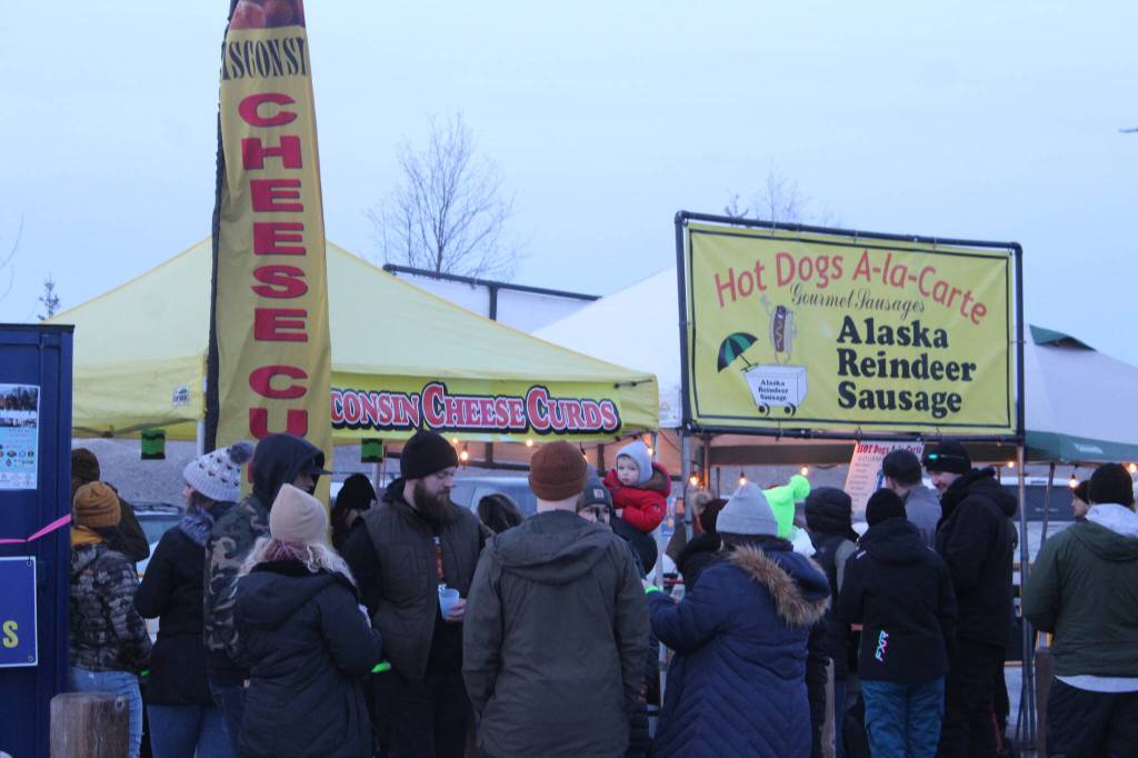 Patrons visit food trucks during Frozen RiverFest on Saturday, Feb. 19, 2022 in Soldotna, Alaska. (Ashlyn OHara/Peninsula Clarion)