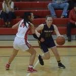 Kenais Amber Nash defends Homers Sophie Ellison during the conference game in Kenai on Saturday, Feb. 19, 2022. (Camille Botello/Peninsula Clarion)