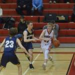 Homers Braden Huffman and Peyton Edens defend Kenais Griffin Gray during the conference game in Kenai on Saturday, Feb. 19, 2022. (Camille Botello/Peninsula Clarion)