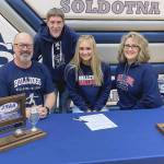 Soldotna High School senior Jolie Widaman signs her National Letter of Intent on Tuesday, Feb. 22, 2022, at Soldotna High School with her father, Matt Widaman; soccer coach, Jimmy Love; and mother, Jill DuFloth. (Photo provided)