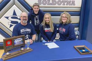 Soldotna High School senior Jolie Widaman signs her National Letter of Intent on Tuesday, Feb. 22, 2022, at Soldotna High School with her father, Matt Widaman; soccer coach, Jimmy Love; and mother, Jill DuFloth. (Photo provided)