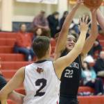 Nikiskis Simon Grenier battles Kenai Centrals Eli McCubbins for the ball Tuesday, Feb. 22, 2022, at Kenai Central High School in Kenai, Alaska. (Photo by Camille Botello/Peninsula Clarion)