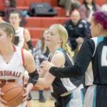 Kenai Central's Denali Bernard keeps the ball from Nikiski's Avery White and Destiny Langston on Tuesday, Feb. 22, 2022, at Kenai Central High School in Kenai, Alaska. (Photo by Camille Botello/Peninsula Clarion)