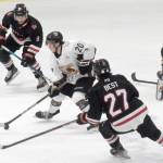 Kenai River Brown Bears forward Ryan Finch splits Evan Tanos and Gavin Best of the Minnesota Magicians on Friday, Feb. 25, 2022, at the Soldotna Regional Sports Complex in Soldotna, Alaska. (Photo by Jeff Helminiak/Peninsula Clarion)
