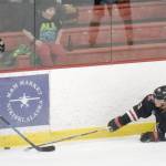 Kenai River Brown Bears forward Noah Holt and Minnesota Magicians forward Samuel Jacobs battle for the puck Friday, Feb. 25, 2022, at the Soldotna Regional Sports Complex in Soldotna, Alaska (Photo by Jeff Helminiak/Peninsula Clarion)