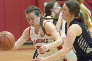 Kenai Central's Logan Satathite dribbles against Soldotna's Josie Sheridan on Friday, Feb. 25, 2022, at Kenai Central High School in Kenai, Alaska. (Photo by Jeff Helminiak/Peninsula Clarion)