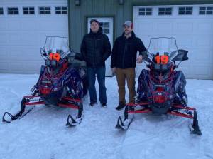 Chad Moore, left, and Travis Temple, right, prepare for the 2022 Iron Dog snow machine race. (Photo provided by Travis Temple)