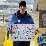 Viktor Tkachenko, who moved to Alaska from Ukraine last year, holds a sign asking NATO for assistance defeating Russian airpower at a protest against the war in Marine Park on Feb. 26, 2022. (Michael S. Lockett / Juneau Empire)