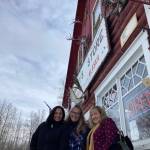 Melissa Botello, Alex Botello and Kim Davis take a photo outside of Nagley's Store in Talkeetna on Friday Feb. 25, 2022. (Camille Botello/Peninsula Clarion)