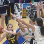 Sewards Lena Jagielski passes under pressure from Jolie Widaman, Katelyn Morrison and Adarra Hagelund on Thursday, March 3, 2022, at Soldotna High School in Soldotna, Alaska. (Photo by Jeff Helminiak/Peninsula Clarion)