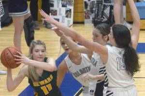 Seward's Lena Jagielski passes under pressure from Jolie Widaman, Katelyn Morrison and Adarra Hagelund on Thursday, March 3, 2022, at Soldotna High School in Soldotna, Alaska. (Photo by Jeff Helminiak/Peninsula Clarion)