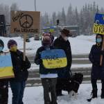 From left to right: Elaine Larson, Judy Johnson, Susie Smalley, Larry Simmons, Trixi the dog and Michele Vasquez demonstrate during the Many Voices Ukraine vigil on Saturday, March 5, 2022, in Soldotna, Alaska. (Camille Botello/Peninsula Clarion)