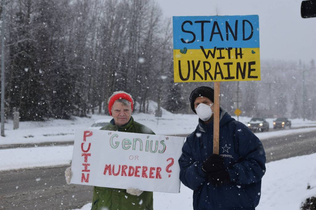 Peggy Mullen and Brent Johnson demonstrate during the Many Voices Ukraine vigil on Saturday, March 5, 2022, in Soldotna, Alaska. (Camille Botello/Peninsula Clarion)