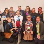 Nikolaevsk School teacher Billeen Carlson, center, shows her Alaska Society for Technology in Education Teacher of the Year award. (Photo provided)