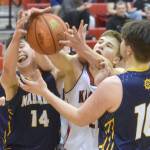 Kenai Centrals Bridger Beck battles Homers Ryan Carroll and Noah Irons for the ball Thursday, March 10, 2022, at the Peninsula Conference tournament at Kenai Central High School in Kenai, Alaska. (Photo by Jeff Helminiak/Peninsula Clarion)