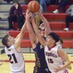 Kenai Centrals Bridger Beck and Jakob Kvasnikoff battle Homers Carter Tennison for the ball Thursday, March 10, 2022, at the Peninsula Conference tournament at Kenai Central High School in Kenai, Alaska. (Photo by Jeff Helminiak/Peninsula Clarion)