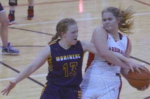 Kenai Central's Emma Beck keeps the ball from Olivia Glasman on Saturday, March 12, 2022, at the Peninsula Conference tournament at Kenai Central High School in Kenai, Alaska. (Photo by Jeff Helminiak/Peninsula Clarion)