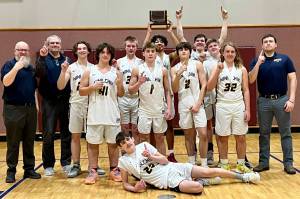 The Ninilchik boys celebrate the Interior Conference title Friday, March 11, 2022, in Tok, Alaska. (Photo provided by team)