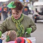 Shanon Davis, the executive director of the Soldotna Chamber of Commerce, hands out candy during the Sweenys St. Patricks Parade in Soldotna on March 17, 2022. (Camille Botello/Peninsula Clarion)