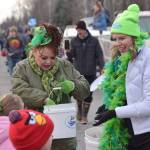 Shanon Davis and Monique Burgin of the Soldotna Chamber of Commerce hand out candy during the Sweeneys St. Patricks Parade in Soldotna on March 17, 2022. (Camille Botello/Peninsula Clarion)