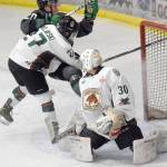 Kenai River Brown Bears forward Barak Braslavski checks Minnesota Wilderness forward William Persson behind Brown Bears goalie Bryant Marks on Thursday, March 17, 2022, at the Soldotna Regional Sports Complex in Soldotna, Alaska. (Photo by Jeff Helminiak/Peninsula Clarion)