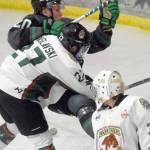 Kenai River Brown Bears forward Barak Braslavski checks Minnesota Wilderness forward William Persson behind Brown Bears goalie Bryant Marks on Thursday, March 17, 2022, at the Soldotna Regional Sports Complex in Soldotna, Alaska. (Photo by Jeff Helminiak/Peninsula Clarion)