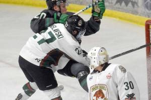 Kenai River Brown Bears forward Barak Braslavski checks Minnesota Wilderness forward William Persson behind Brown Bears goalie Bryant Marks on Thursday, March 17, 2022, at the Soldotna Regional Sports Complex in Soldotna, Alaska. (Photo by Jeff Helminiak/Peninsula Clarion)