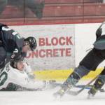 Kenai River Brown Bears forward Ryan Finch battles Minnesota Wilderness defenseman Severi Sulonen and forward Cole Gordon for the puck Friday, March 18, 2022, at the Soldotna Regional Sports Complex in Soldotna, Alaska. (Photo by Jeff Helminiak/Peninsula Clarion)