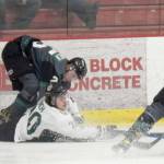Kenai River Brown Bears forward Ryan Finch battles Minnesota Wilderness defenseman Severi Sulonen and forward Cole Gordon for the puck Friday, March 18, 2022, at the Soldotna Regional Sports Complex in Soldotna, Alaska. (Photo by Jeff Helminiak/Peninsula Clarion)